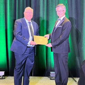 Hassan Baaj receives his certificate on stage.