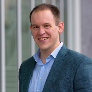 A man smiles at the camera.