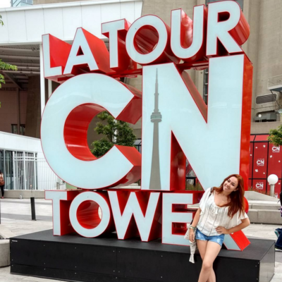 Student standing at the CN Tower's entrance 