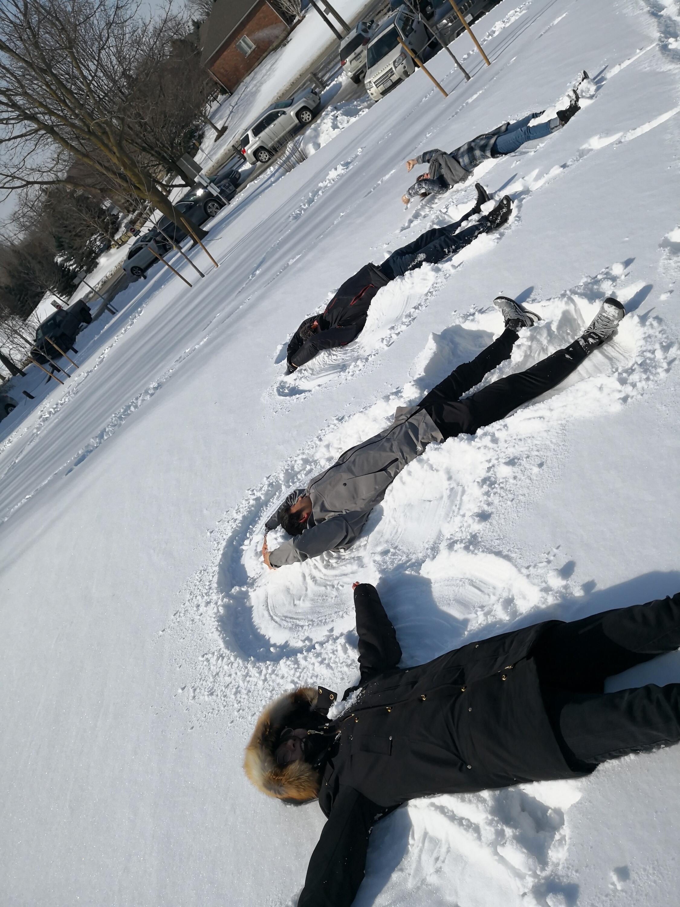 people doing snow angels
