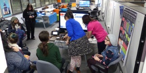 Students sittting around in workshop space.