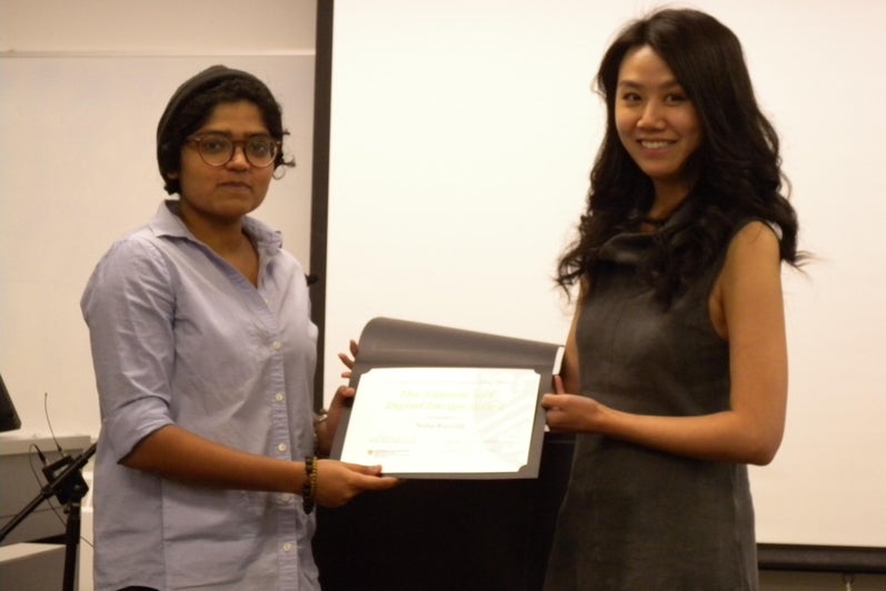 Neha Ravella receives the Rhetoric and Digital Design Award from Lai-Tze Fan