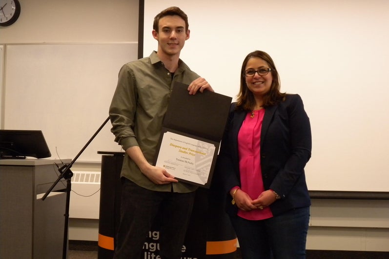 Trenton McNulty receives the Diaspora and Transnational Studies Prize from Lamees Al Ethari.