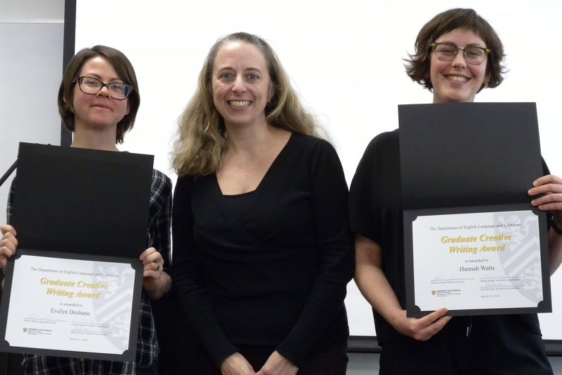 Hannah Watts and Evelyn Deshane receive the Graduate Creative Writing Award from Veronica Austen.