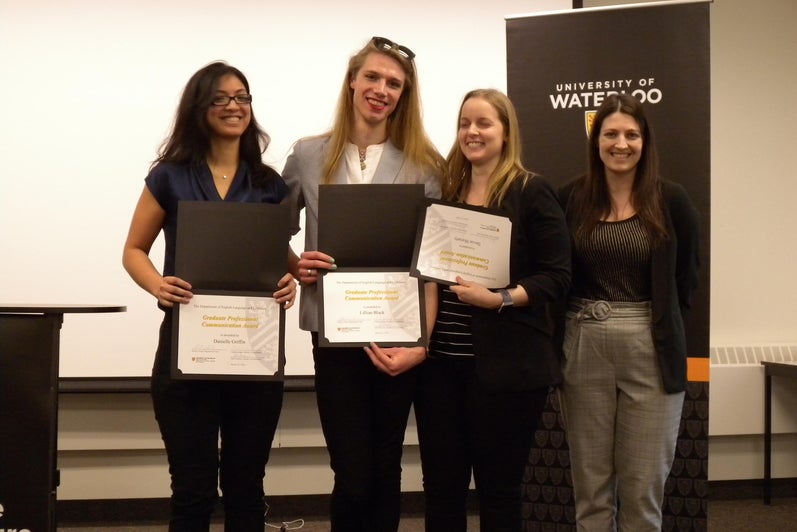 Devon Moriarty, Lillian Black, and Danielle Griffin receive the Graduate Professional Communication Award from  Megan Selinger