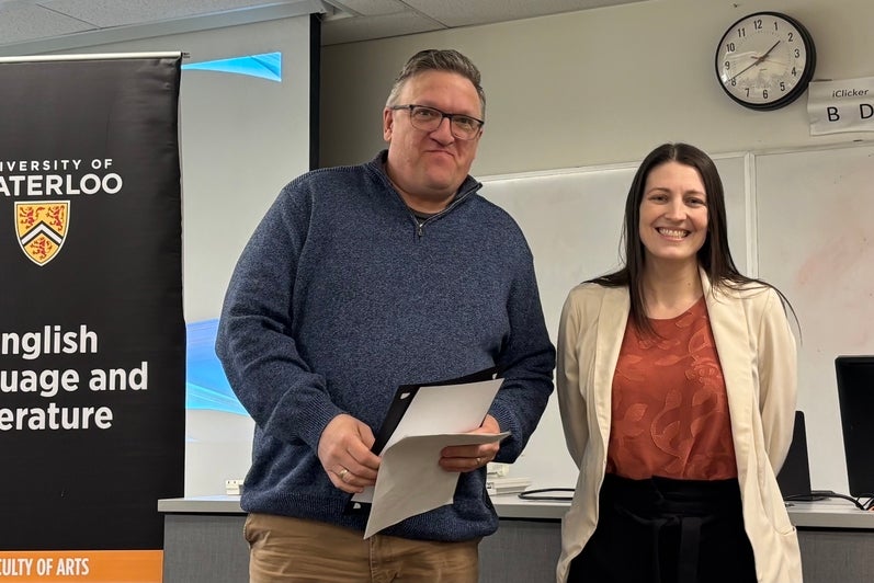 Dr. Megan Selinger presents Steve Wood with the Albert Shaw Annual Poetry Award.