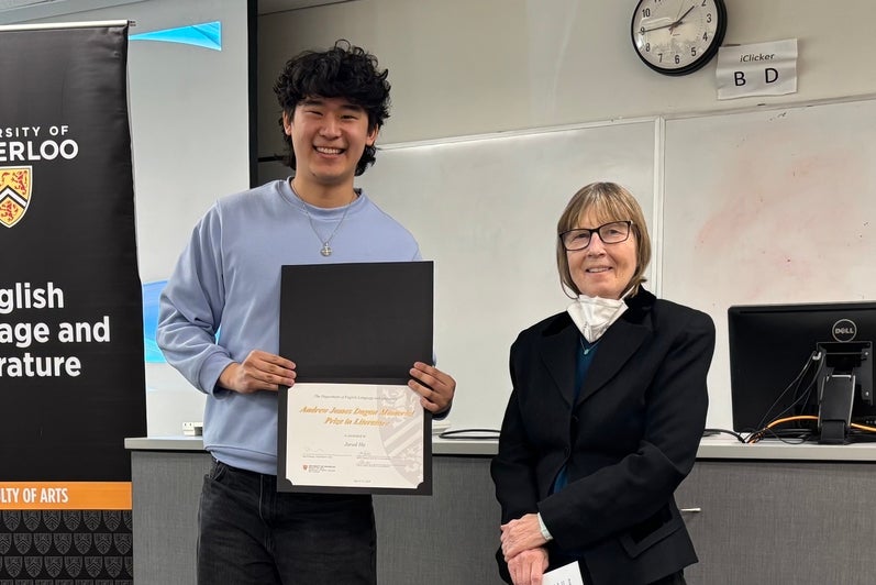 Dr. Carol Acton presents Jared He with the Andrew James Dugan Prize in Literature.