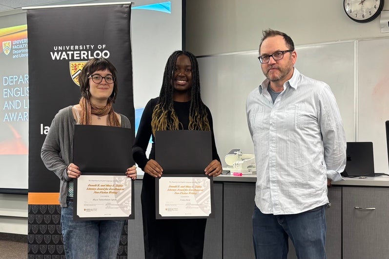 Dr. Andrew McMurry presents Maya Tannenbaum-Lipton and Aviana Reid with the Donald R. and Mary E. Snider Literary Award for Excellence in Non-Fiction Writing.