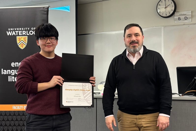 Dr. Carter Neal presents Orlando Zhou with the Emerging English Scholar Award.