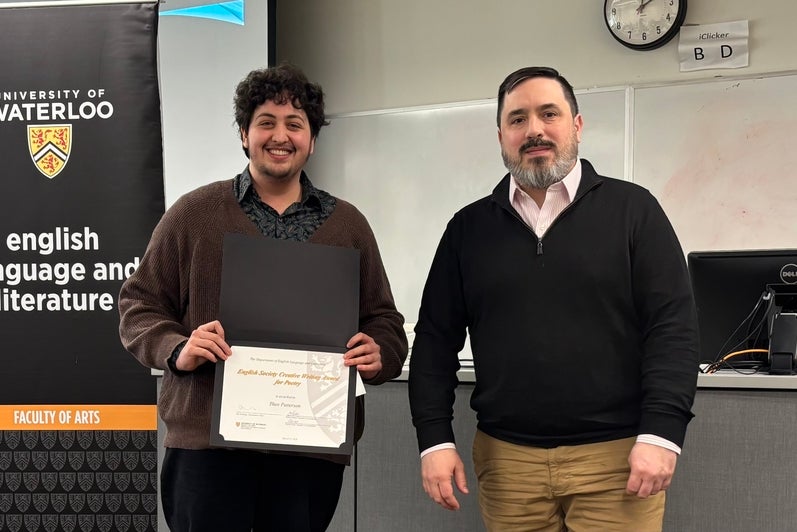 Dr. Carter Neal presents Theo Patterson with the English Society Creative Writing Award for Poetry.