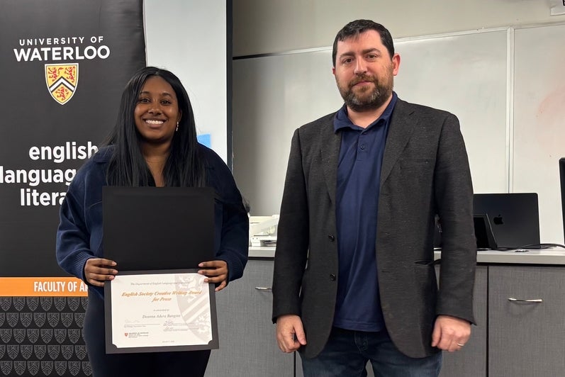 Dr. John Savarese presents Deanna Adera Bangine with the English Society Creative Writing Award for Prose .