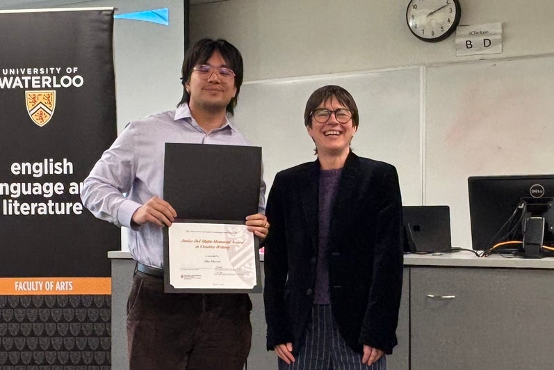 Dr. Tristanne Connolly presents Jiho Mercer with the Janice Del Matto Memorial Award in Creative Writing.