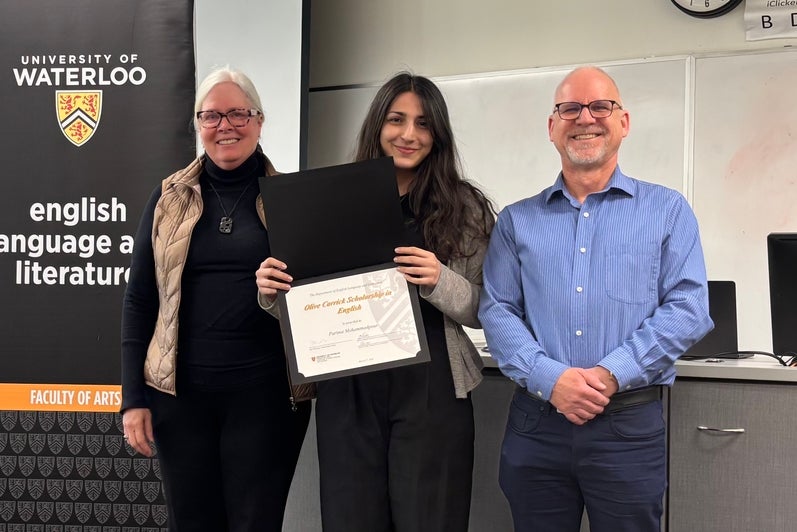 Dr. Donor Nancy Mattes and Bruce Dadey present Parima Mohammadpour with the Olive Carrick Scholarship in English.