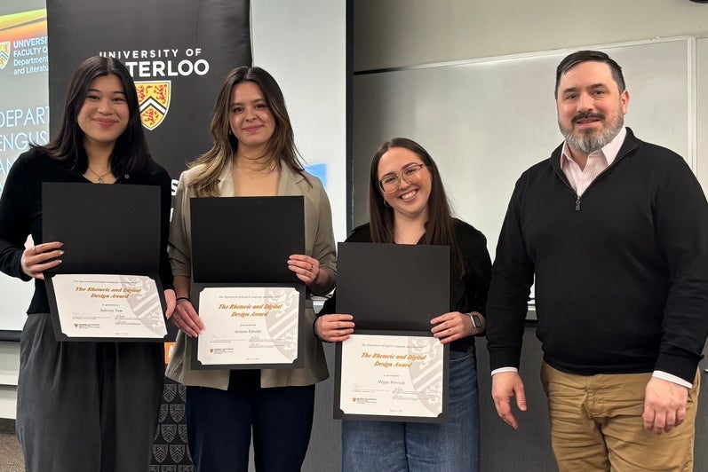 Dr. Carter Neal presents Sabrina Tam, Arriana Edralin, and Megan Storozuk with the Rhetoric and Digital Design Award.