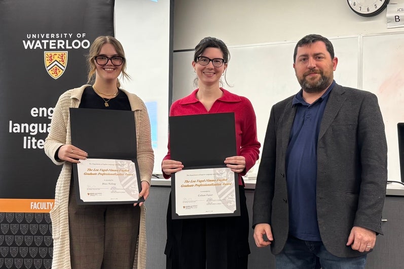 Dr. John Savarese presents Blaze Welling and Colleen Foster with the Lea Vogel-Nimmo English Graduate Professionalization Award.