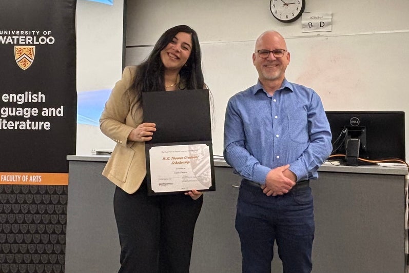 Dr. Bruce Dadey presents Laila Emara with the W.K. Thomas Graduate Scholarship.