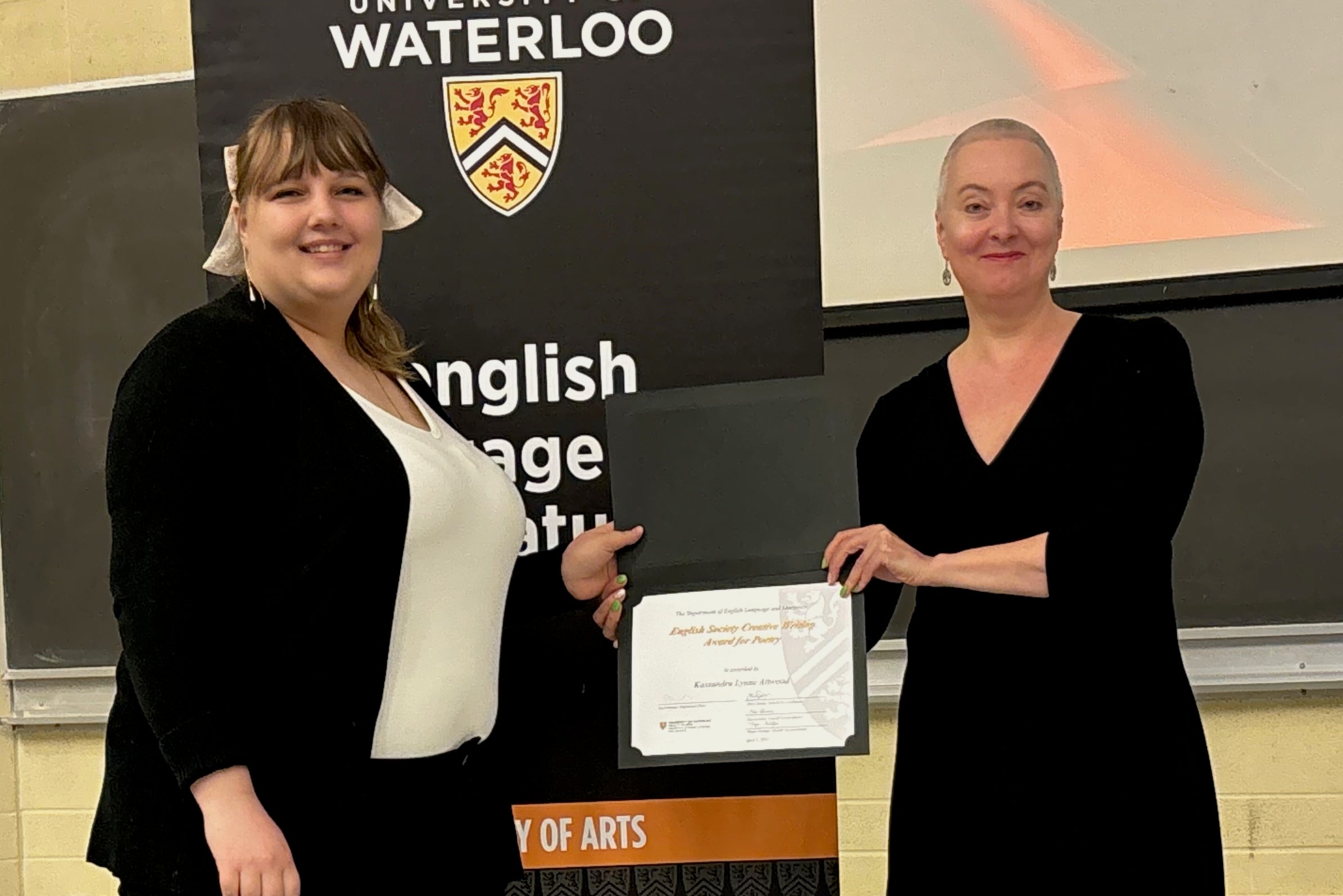 Kassandra Lynne Attwood receives the English Society Creative Writing Award for Poetry from Sarah Tolmie.