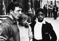 Photograph of three people in London.