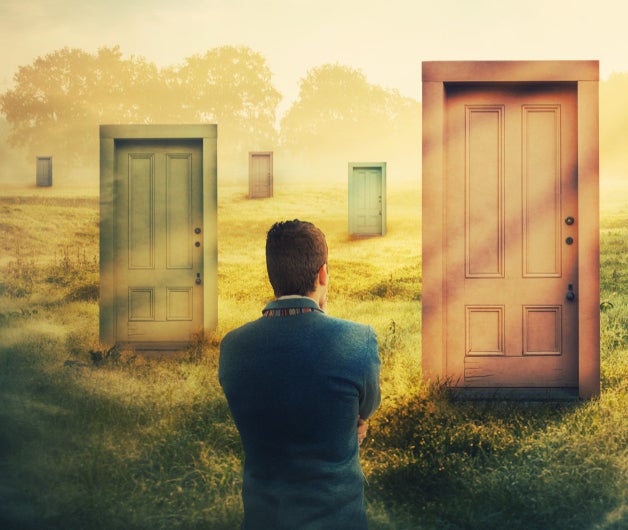 Image of man standing in a field with multiple doors.