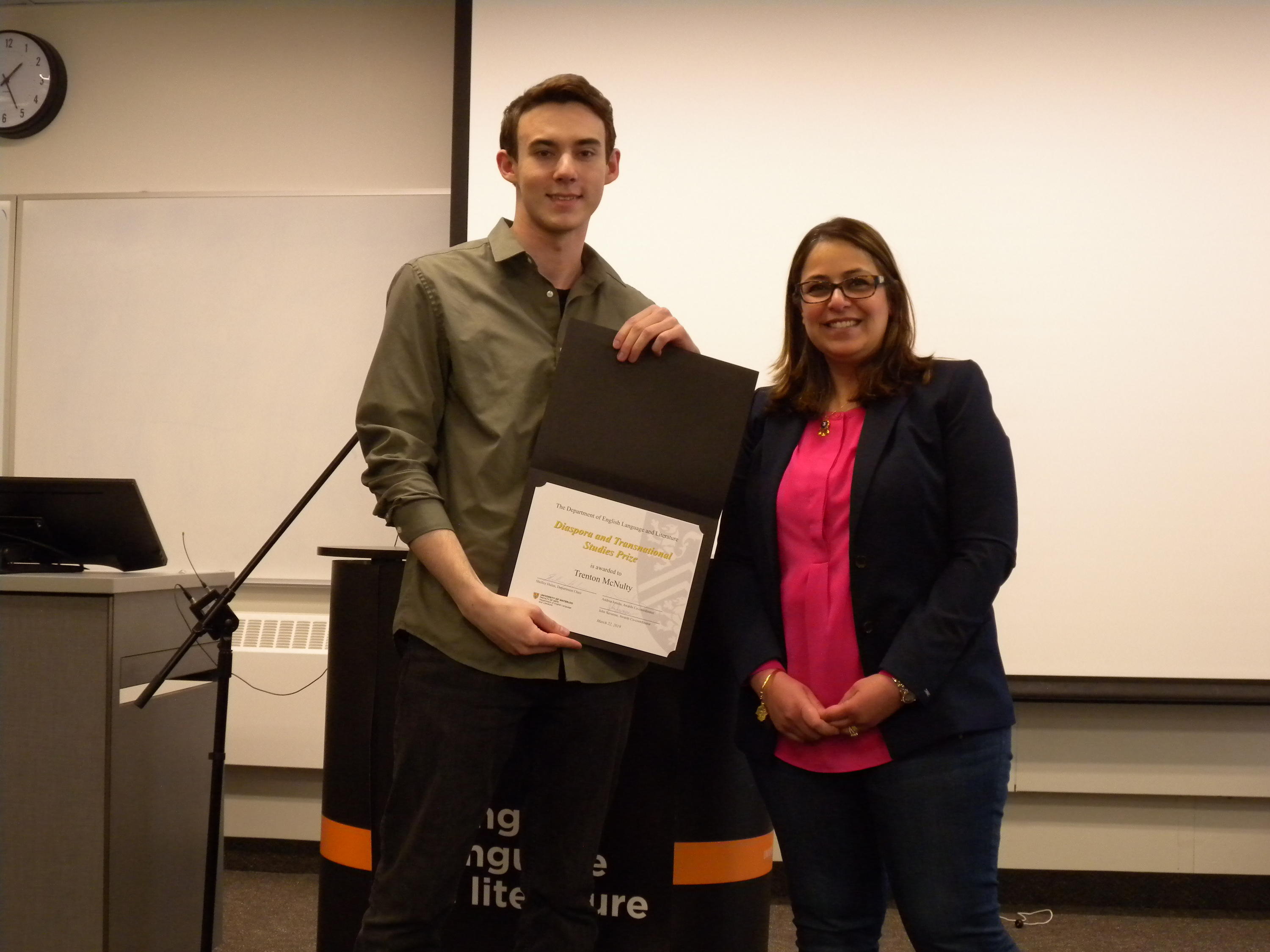 Trenton McNulty receives the Diaspora and Transnational Studies Prize from Lamees Al Ethari.