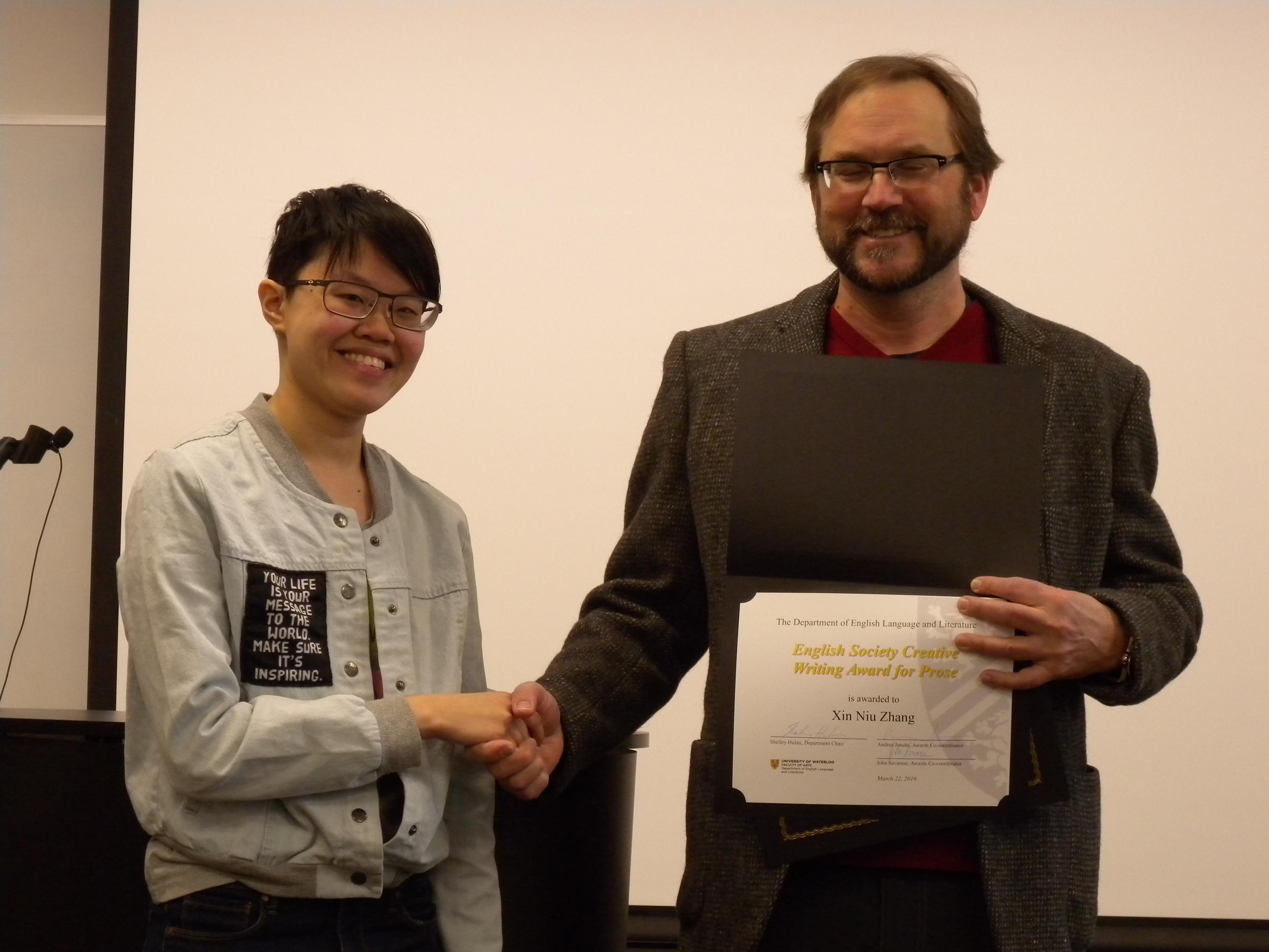 Xin Niu Zhang receives the English Society Creative Writing Award for Prose and the Albert Shaw Poetry Prize from Andrew McMurry