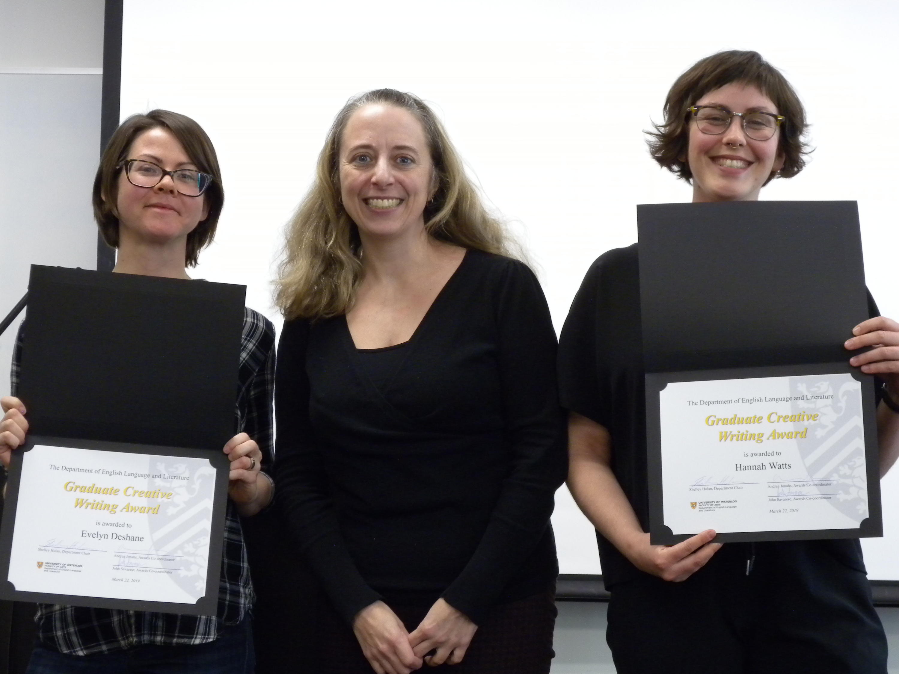 Hannah Watts and Evelyn Deshane receive the Graduate Creative Writing Award from Veronica Austen.