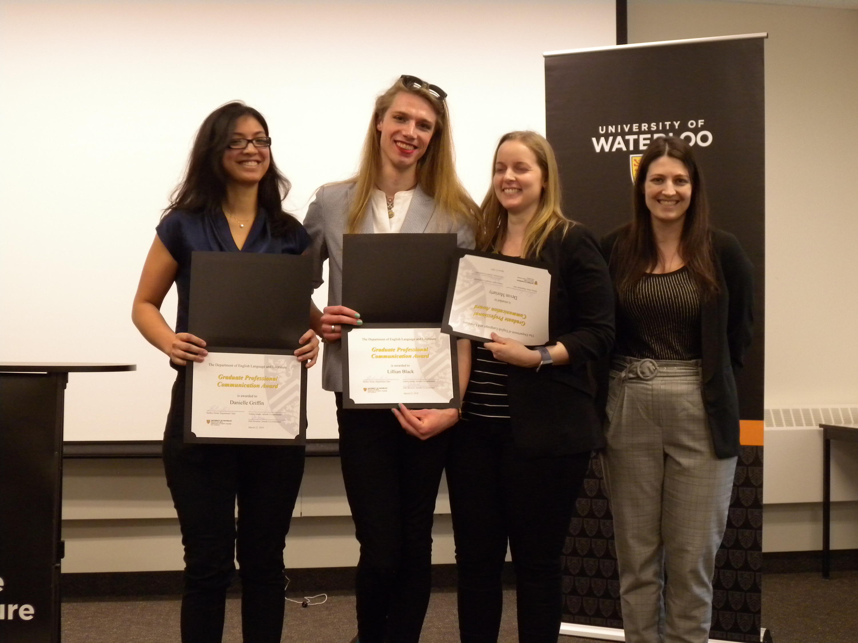 Devon Moriarty, Lillian Black, and Danielle Griffin receive the Graduate Professional Communication Award from  Megan Selinger