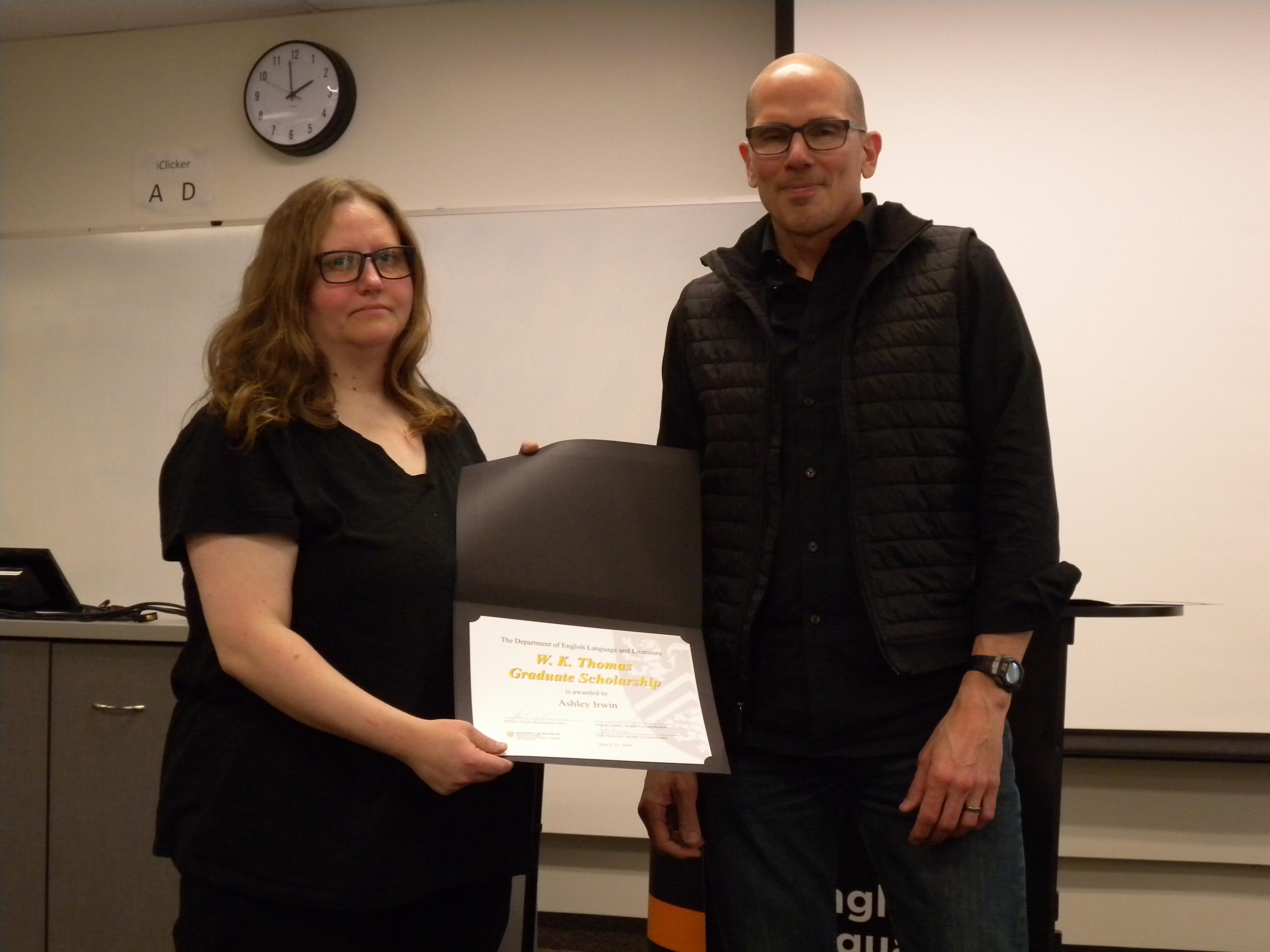 Ashley Irwin receives the W.K. Thomas Graduate Scholarship and David Nimmo English Graduate Scholarships from Marcel O’Gorman.