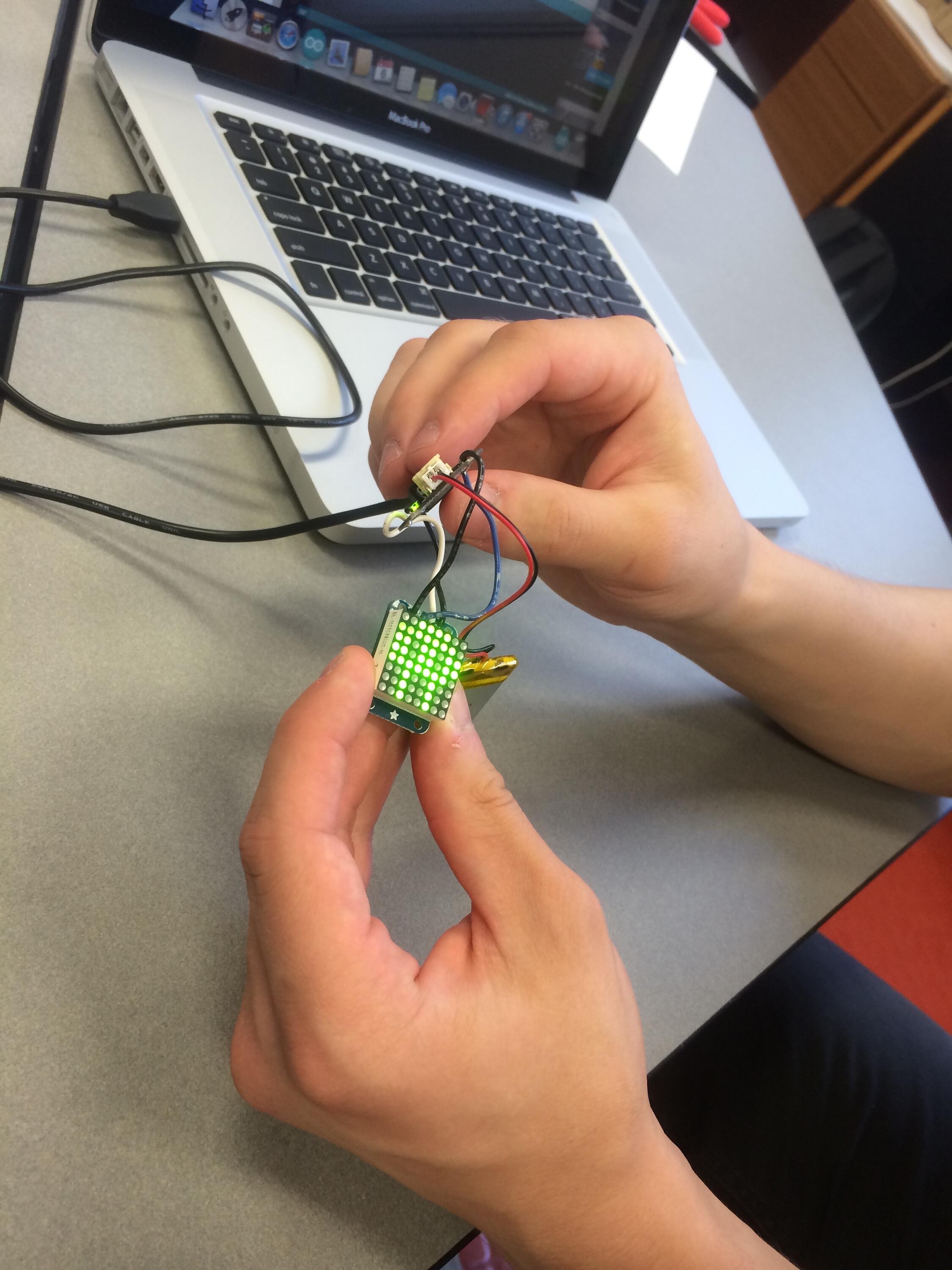 Photo of person making a circuit.