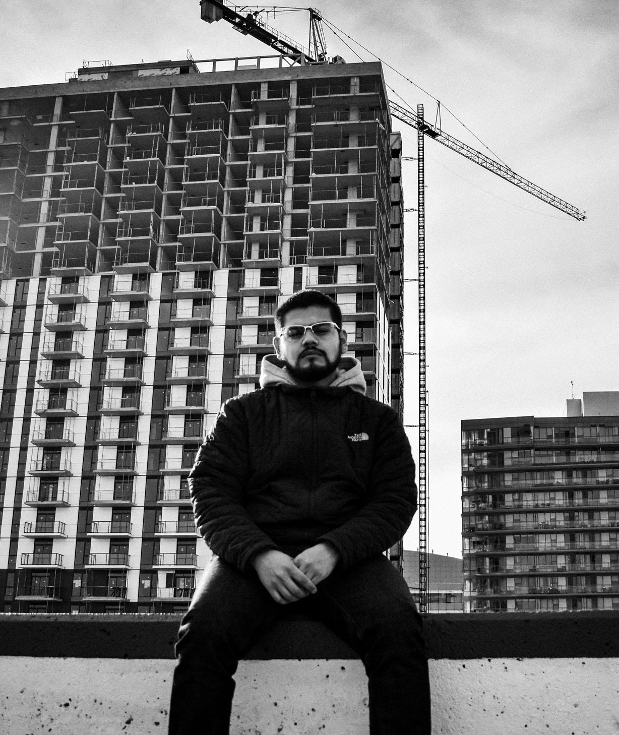 Photo of man in front of a building in construction.