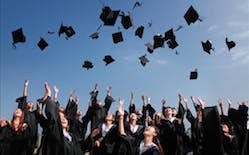 Photo of graduates throwing caps in the air.