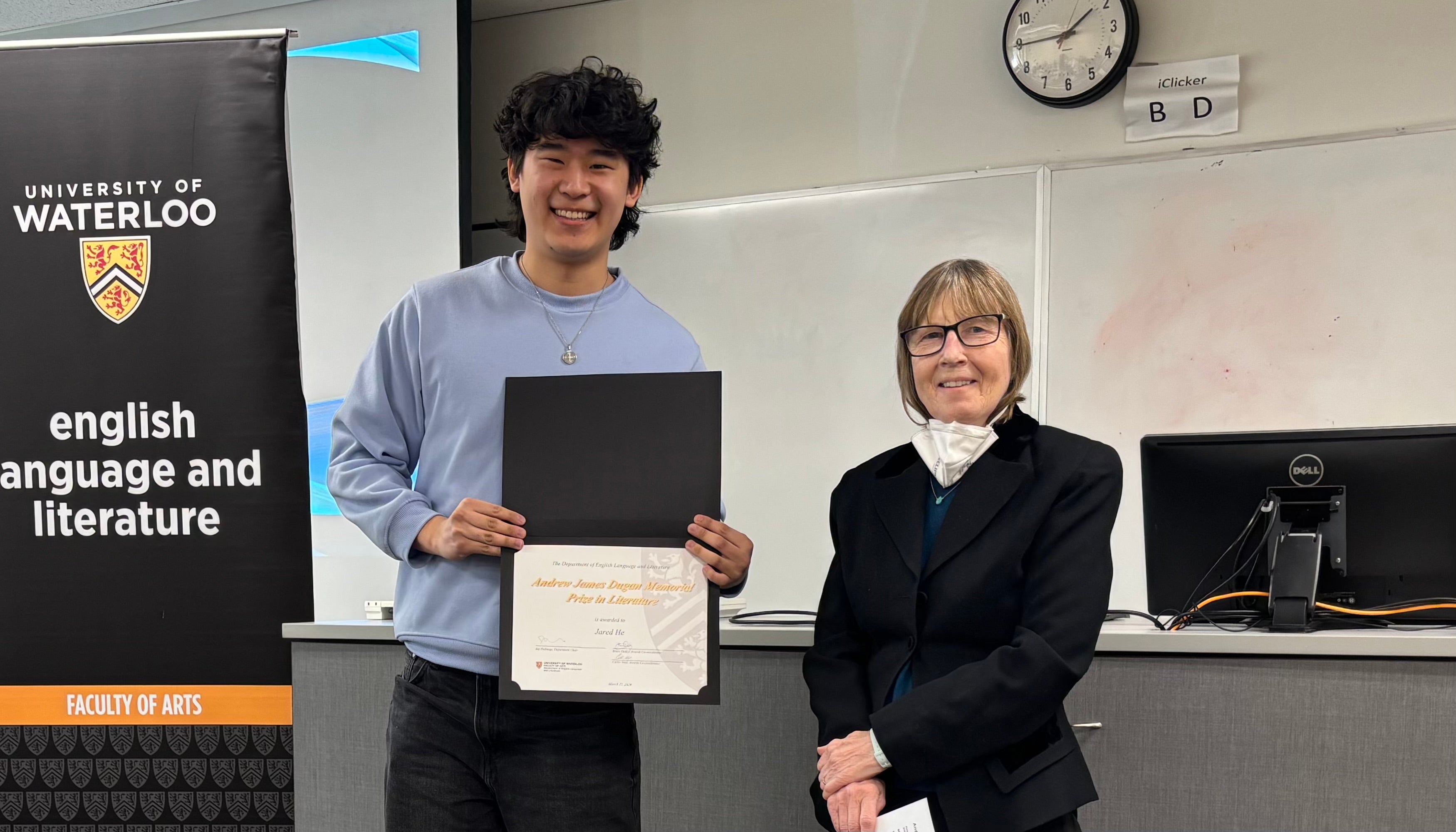 Dr. Carol Acton presents Jared He with the Andrew James Dugan Prize in Literature.