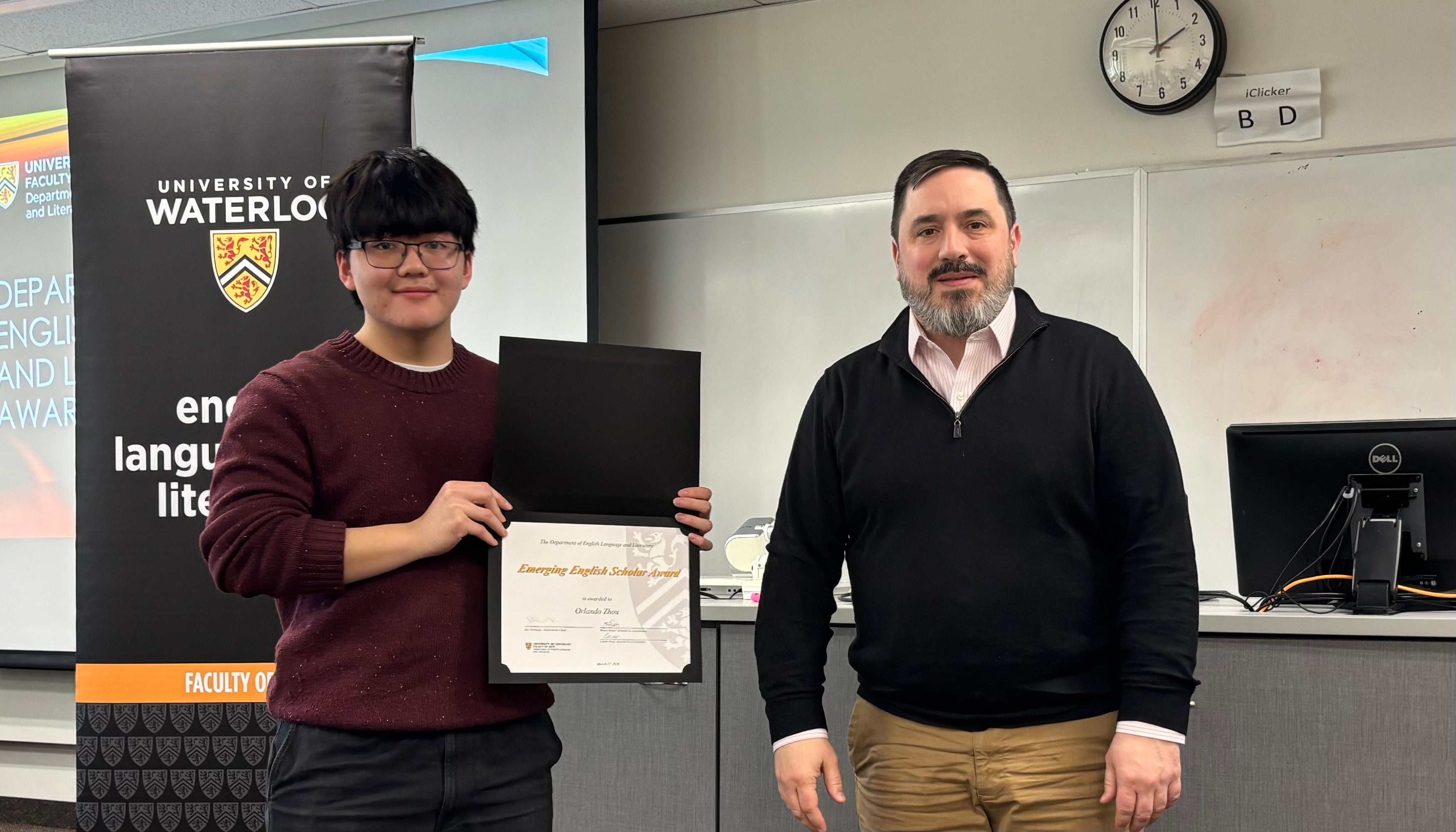 Dr. Carter Neal presents Orlando Zhou with the Emerging English Scholar Award.
