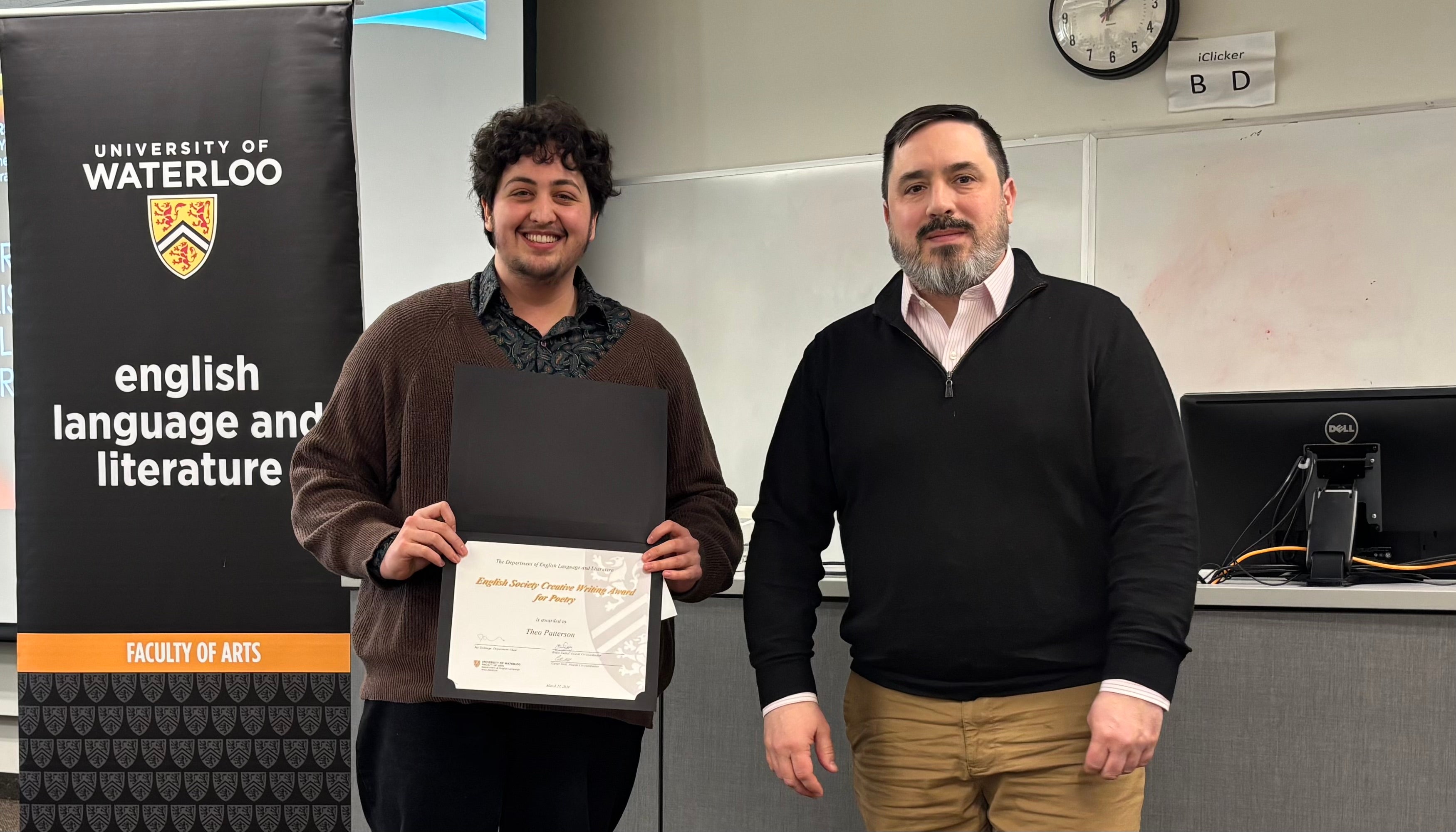 Dr. Carter Neal presents Theo Patterson with the English Society Creative Writing Award for Poetry.