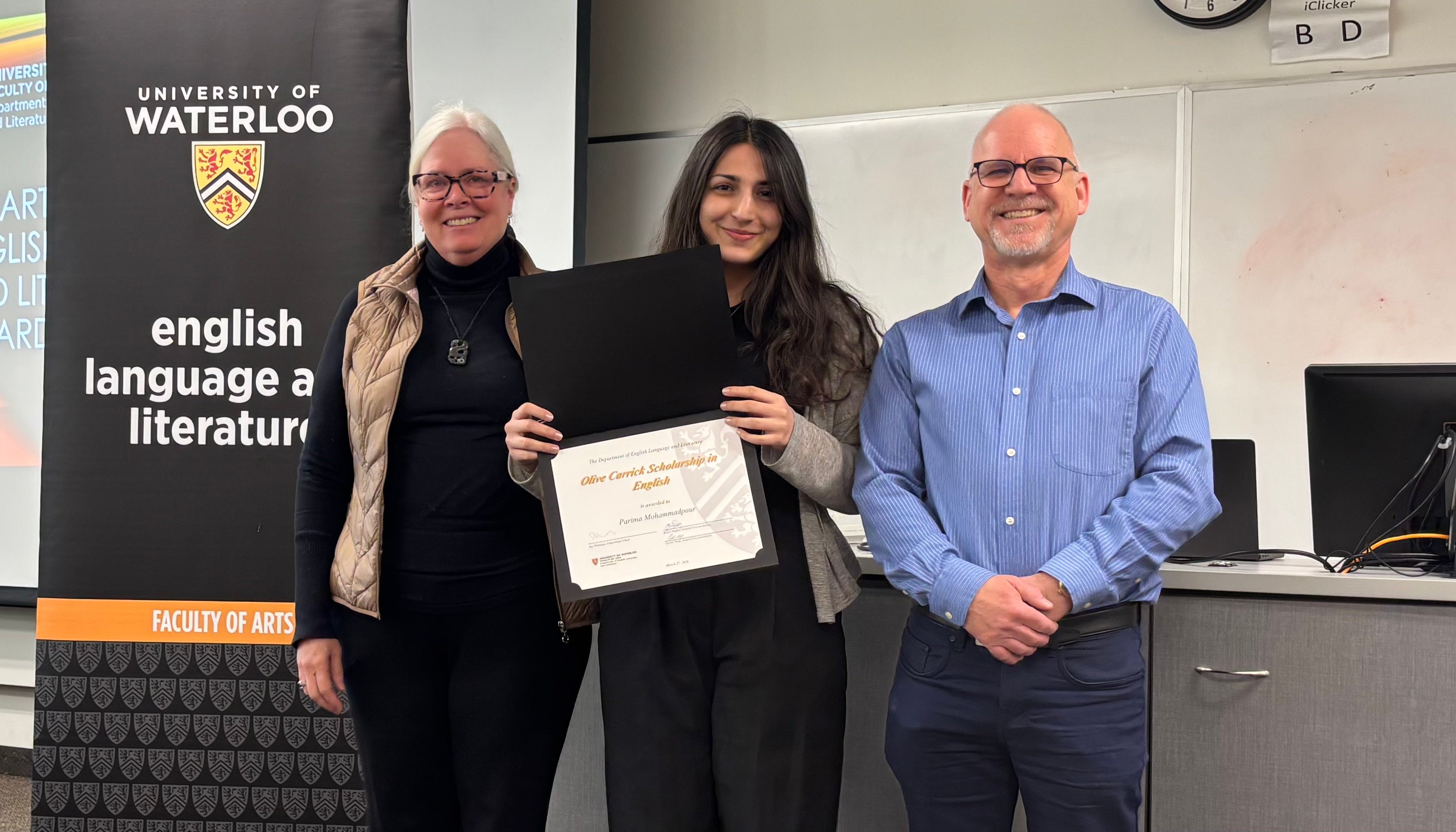 Dr. Donor Nancy Mattes and Bruce Dadey present Parima Mohammadpour with the Olive Carrick Scholarship in English.