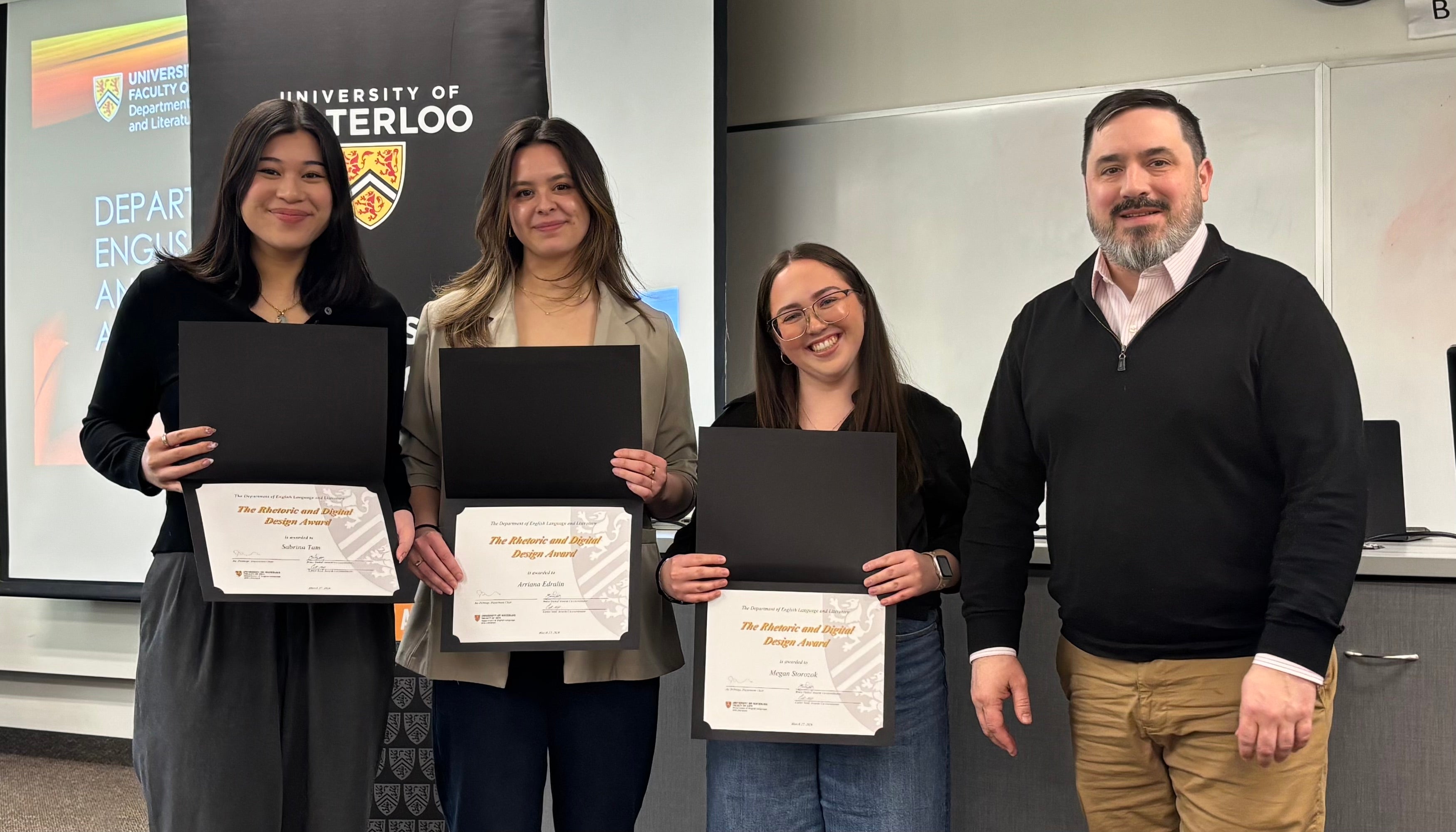 Dr. Carter Neal presents Sabrina Tam, Arriana Edralin, and Megan Storozuk with the Rhetoric and Digital Design Award.