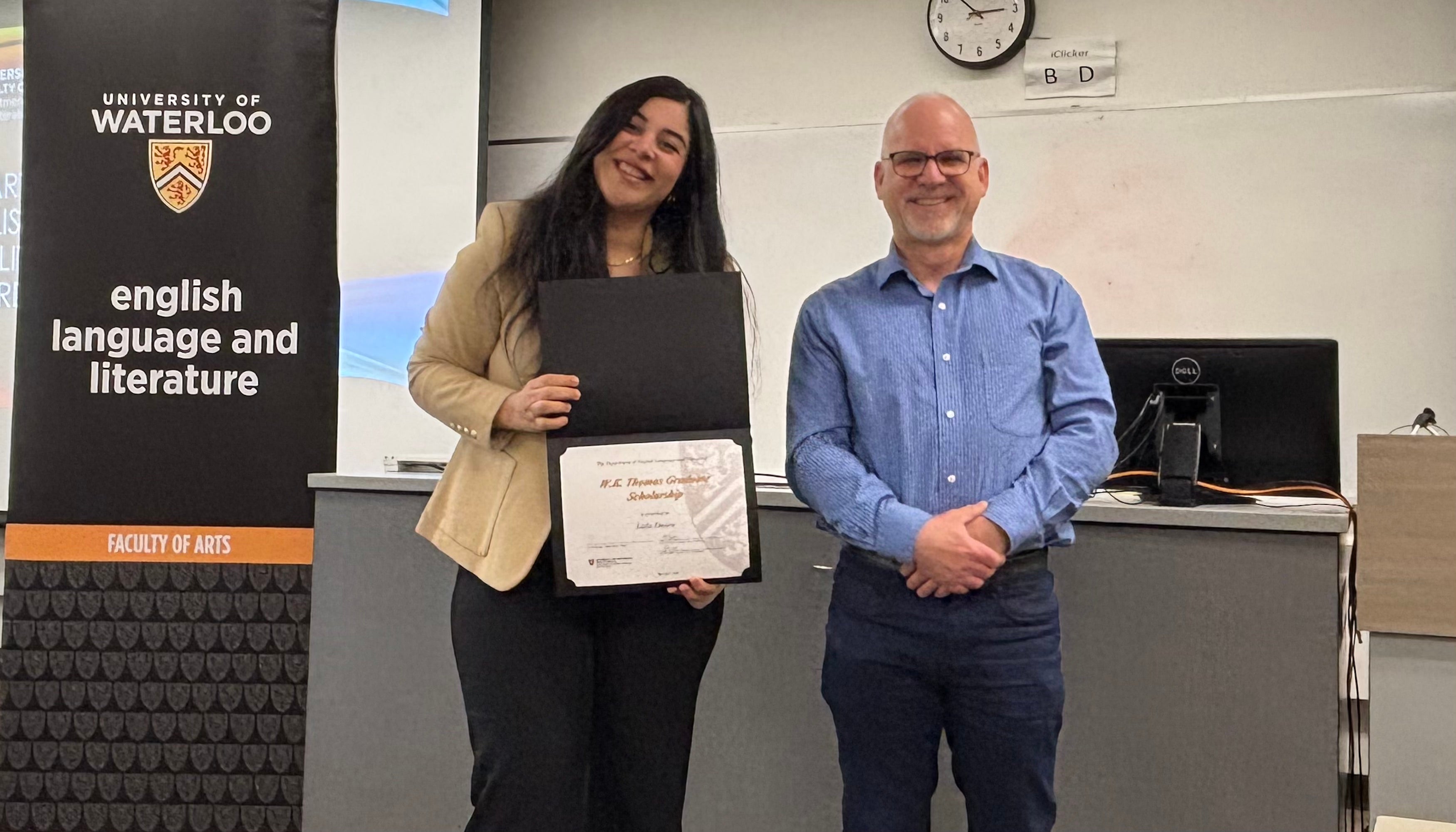 Dr. Bruce Dadey presents Laila Emara with the W.K. Thomas Graduate Scholarship.