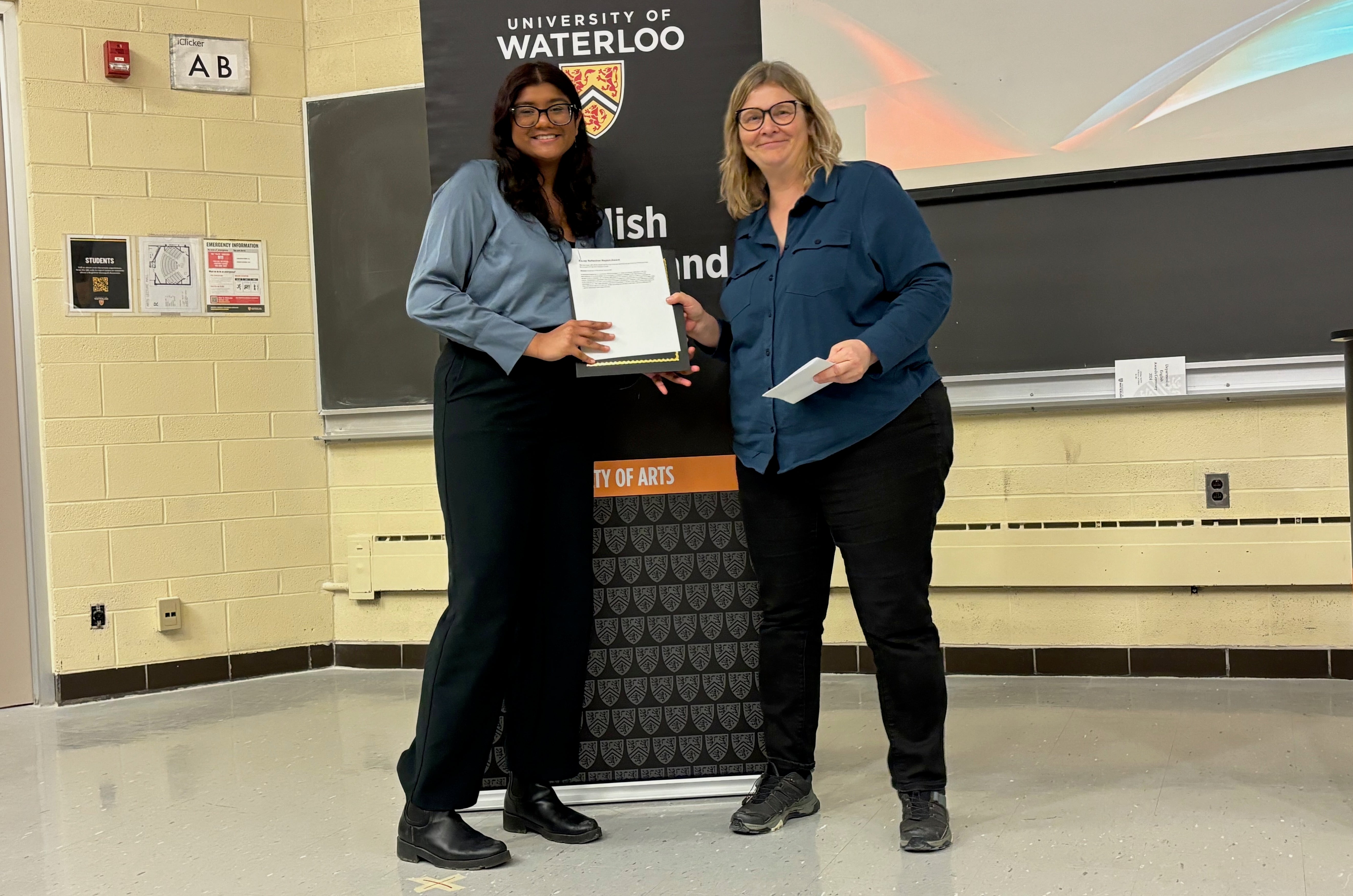 Vyshnavi Rajeevan receives the Co-op Reflective Report Award from Victoria Lamont.