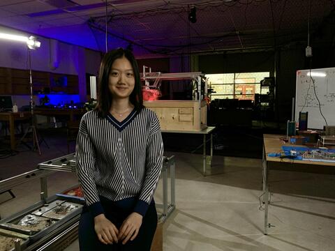 Michelle Kao standing in front of equipment at STAR Labs of Magellan Aerospace