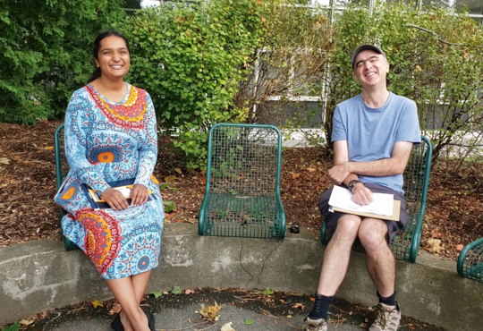 Urja Nandivada and Prof. Jim Martin Sitting Beside Each Other on a Bench