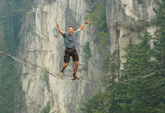 Brent Plumley traversing canyon on suspended rope