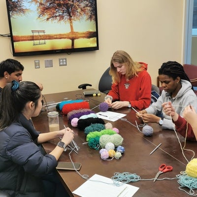 Group of students knitting 