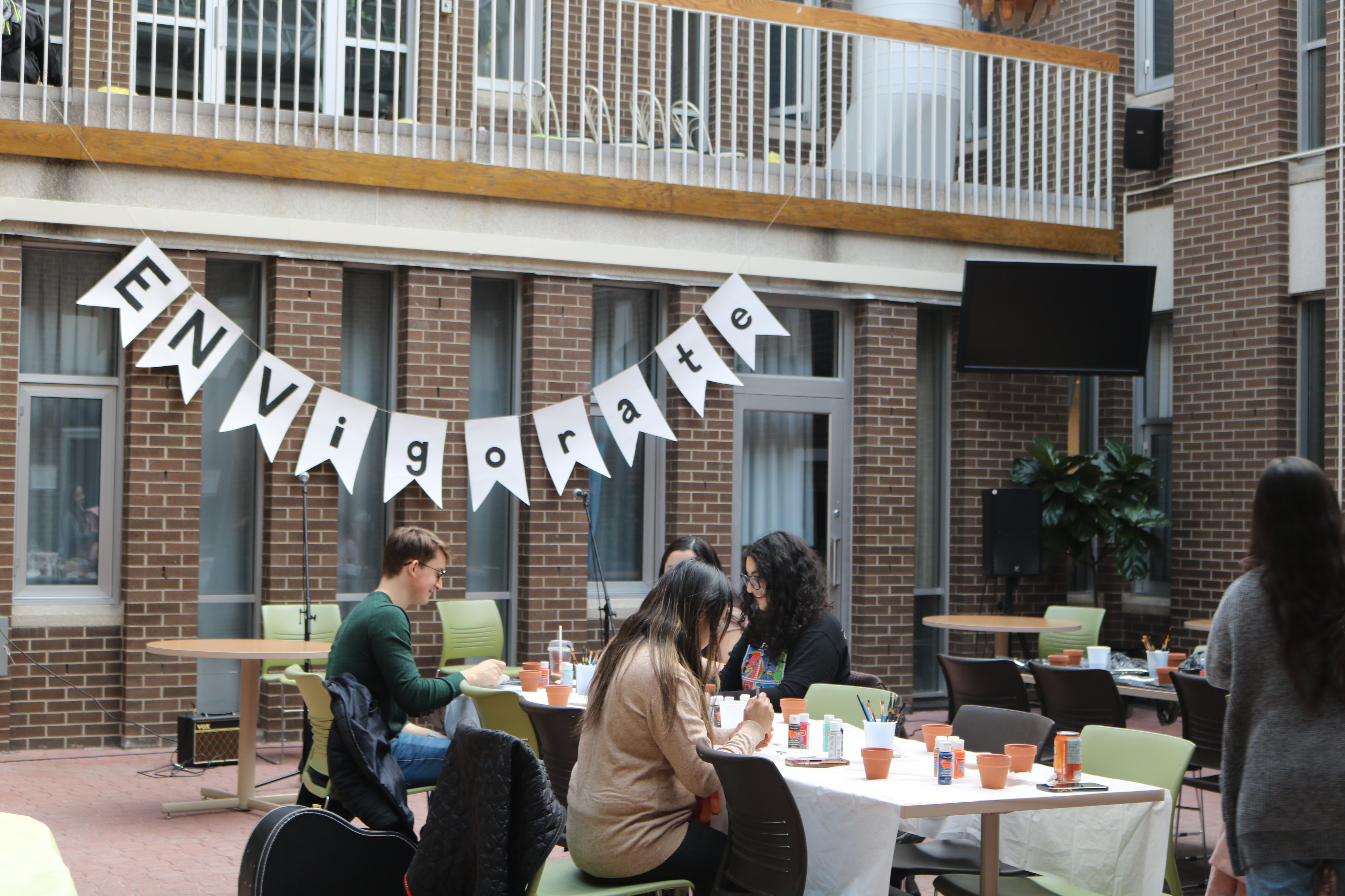 Banner that reads "ENVIGORATE" hung up in the Environment 1 courtyard.