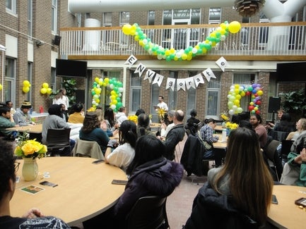 ENVigorate 2025 celebration in the EV1 courtyard, decorated with green and yellow decorations and a banner that says "ENVIGORATE"