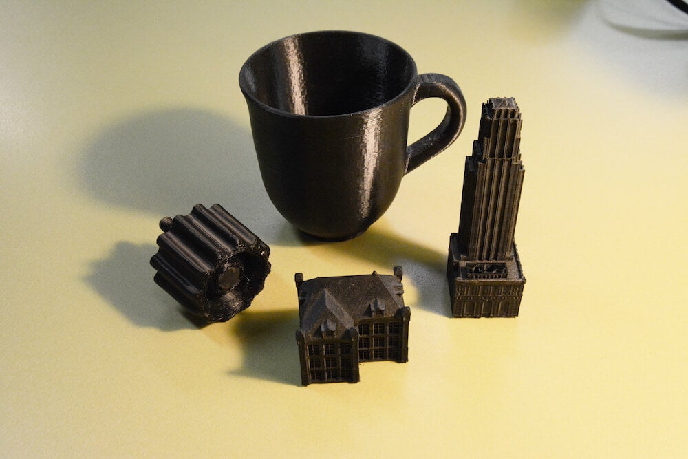 A 3D printed hotel, mansion, cup and a knob