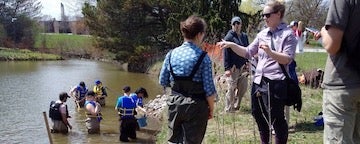 Students working along the river bank