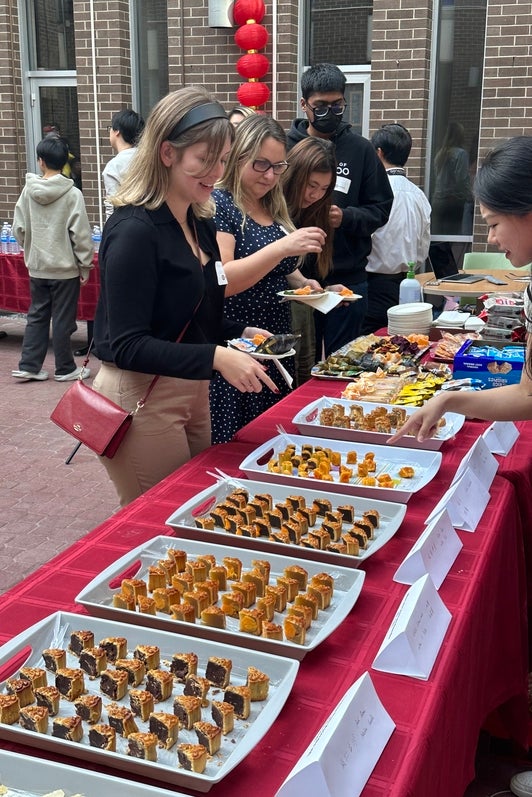 Attendees grabbing moon cakes and other snacks (2)