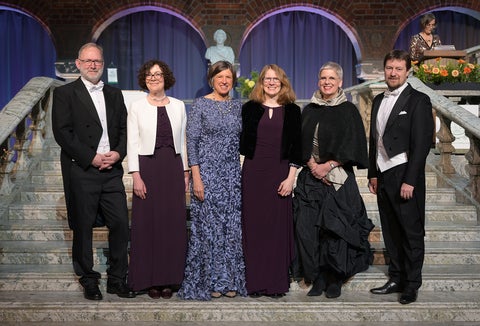 Six inductees into the Royal Swedish Academy of Agriculture and Forestry standing on a staircase dressed in formal attire.