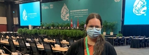 Student at COP15 convention room wearing a mask