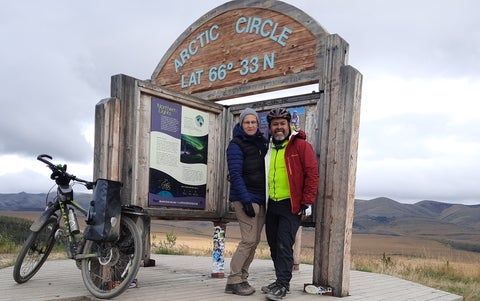Maren Oelbermann and Pedro Gonzalez Hernandez at the Arctic Circle marker on the Dempster Highway